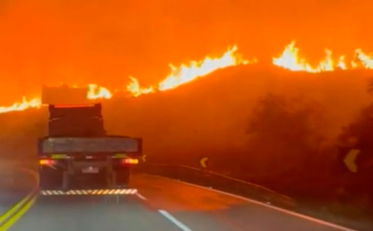 Foto: ReproduÃ§Ã£o/Redes Sociais - De acordo com o Corpo de Bombeiros, uma equipe foi acionada Ã s 18h para combate Ã s chamas. O incÃªndio comeÃ§ou apÃ³s uma pequena carreta pegar fogo Ã s margens da rodovia e as chamas passarem para a vegetaÃ§Ã£o